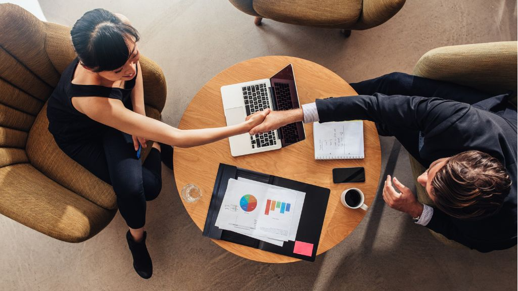 business owner shaking hands with AI SEO agency consultant after signing SEO contract, digital marketing, ai seo services