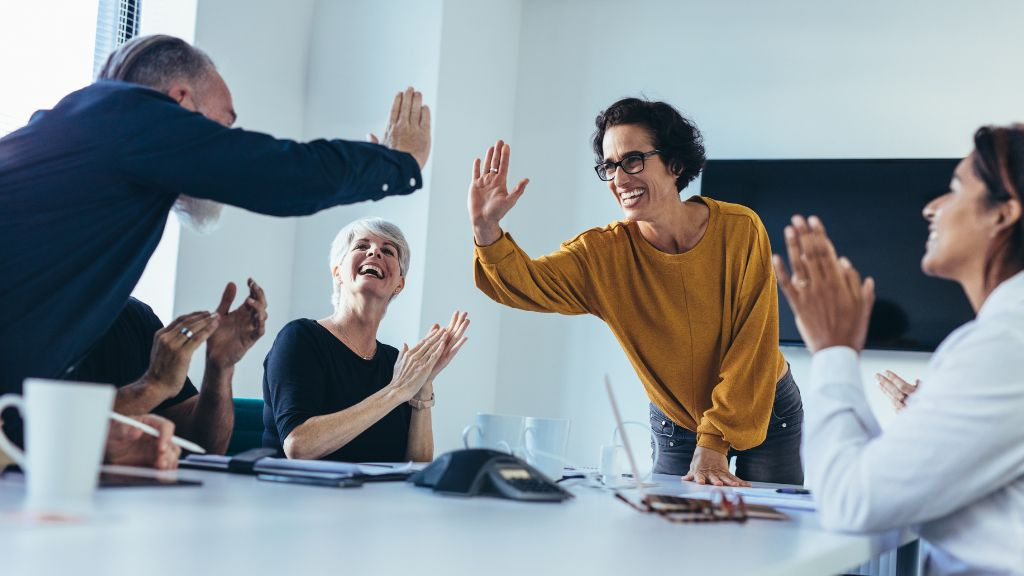 Business team celebrating explosive growth with ai marketing agency and campaign success